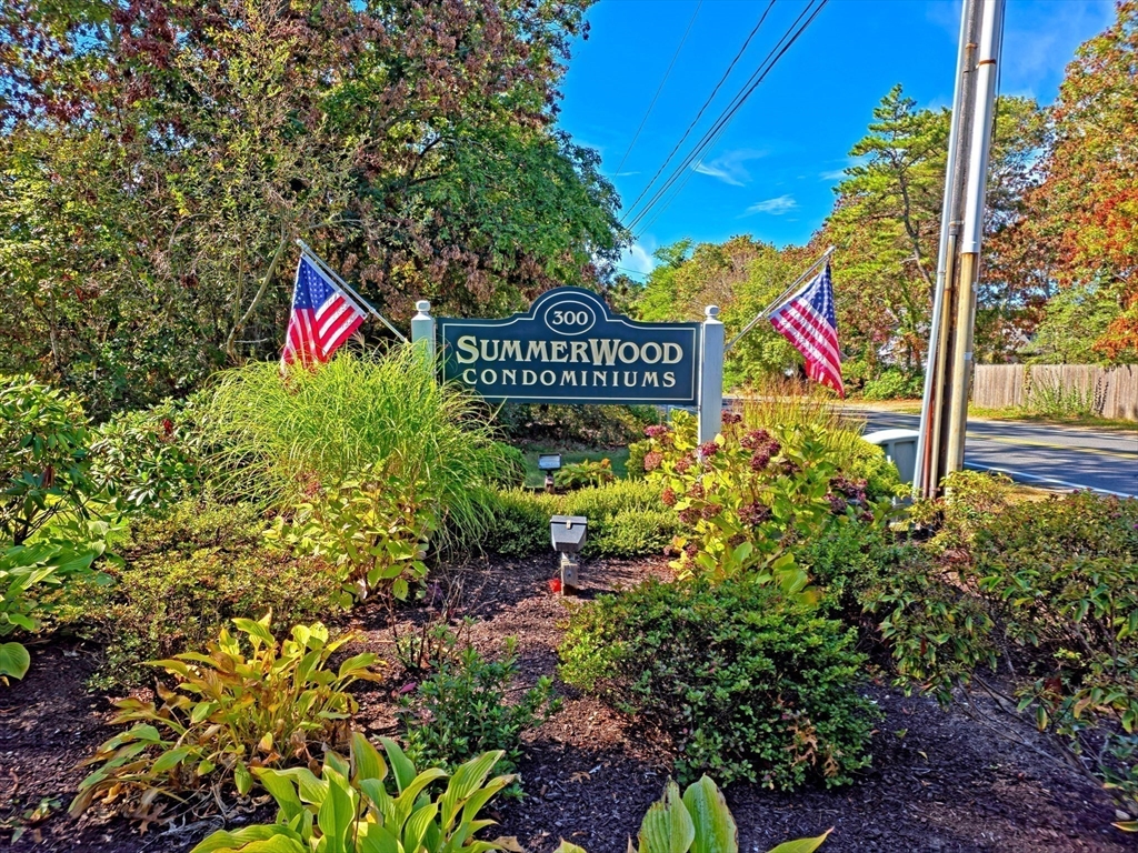 300 Falmouth Road, Unit 18E Mashpee, MA 02649 - Photo 32 of 33 a sign that is sitting in front of flowers