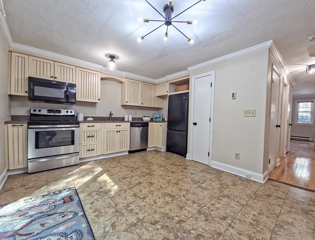 300 Falmouth Road, Unit 18E Mashpee, MA 02649 - Photo 8 of 33 a kitchen with stainless steel appliances granite countertop a stove top oven a sink and a refrigerator