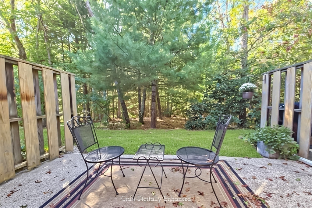 300 Falmouth Road, Unit 18E Mashpee, MA 02649 - Photo 10 of 33 a view of a chairs and backyard with a barbeque