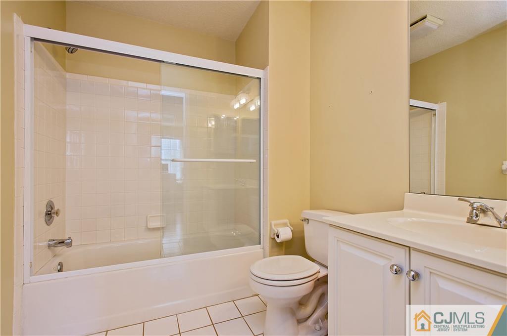 192 Nebula Road Piscataway, NJ 08854 - Photo 17 of 19 a bathroom with a sink mirror vanity and toilet