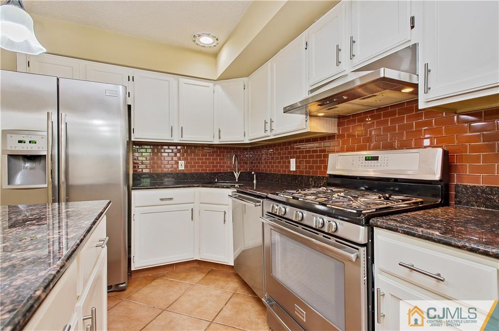 192 Nebula Road Piscataway, NJ 08854 - Photo 6 of 19 a kitchen with granite countertop a stove sink and cabinets