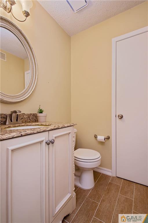 192 Nebula Road Piscataway, NJ 08854 - Photo 8 of 19 a bathroom with a sink a toilet and a mirror