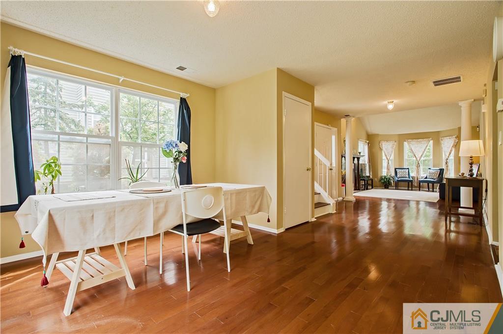 192 Nebula Road Piscataway, NJ 08854 - Photo 10 of 19 a view of a dining room with furniture floor to ceiling window and wooden floor