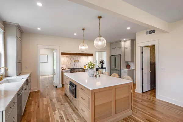 a kitchen with a sink and wooden floor