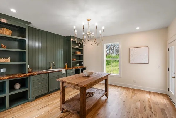a kitchen with a sink and a stove top oven