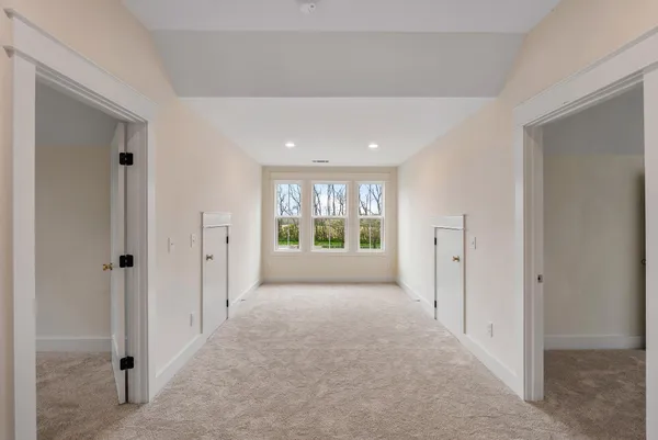 an empty room with windows and closet