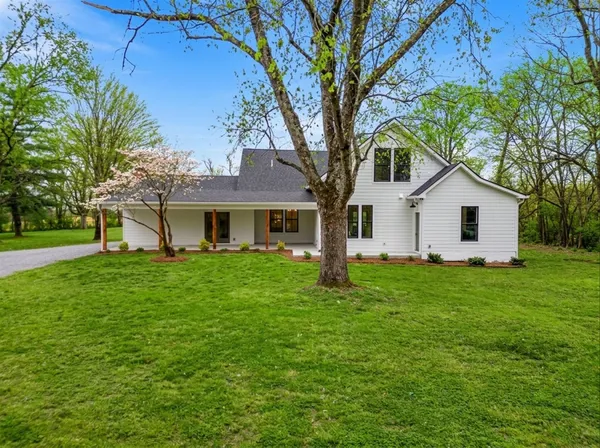 a house that has a tree in front of the house