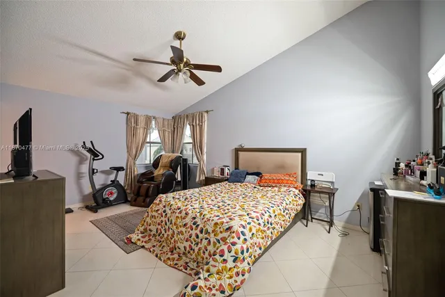 a bedroom with a bed gym equipment and a window