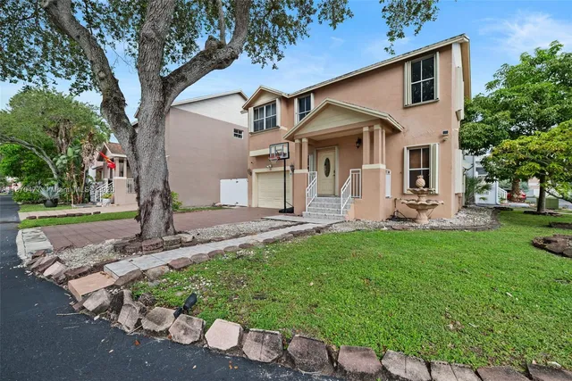 a front view of a house with garden