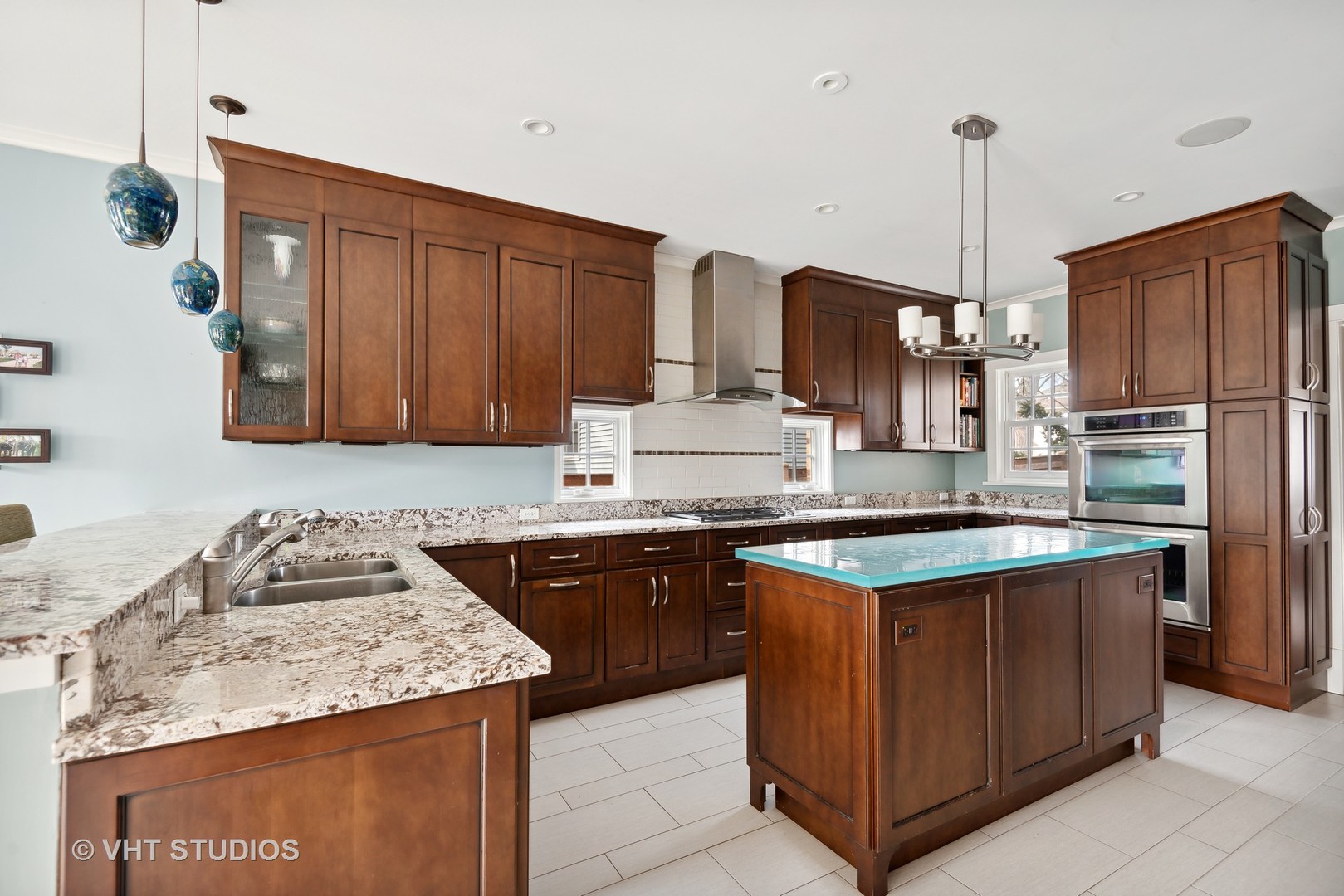 1601 Central Avenue Wilmette, IL 60091 - Photo 10 of 32 a kitchen with granite countertop kitchen island stainless steel appliances a sink stove and refrigerator