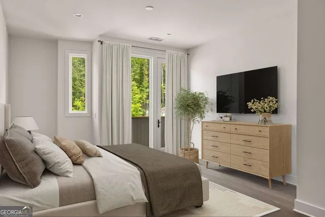 a bedroom with a bed and flat tv screen