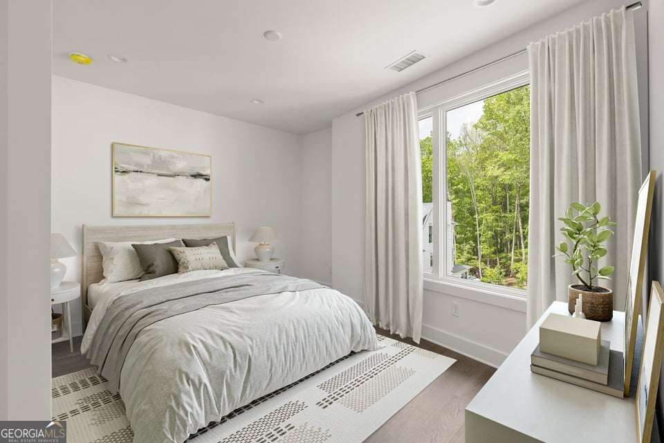 11554 Serenbe Lane Chattahoochee Hills, GA 30268 - Photo 3 of 16 a bedroom with a bed and a window