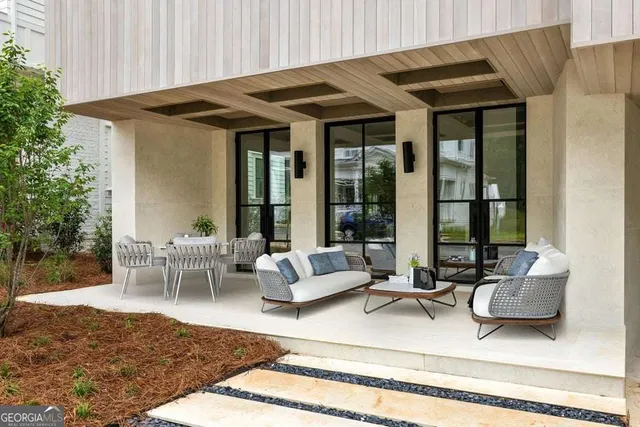a view of patio with a table and chairs and potted plants