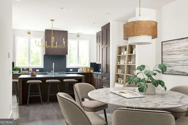 a kitchen with a table and chairs in it