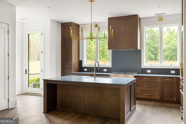 a kitchen with a window a sink and a refrigerator