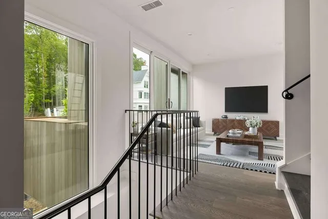 a view of a living room and a window with furniture