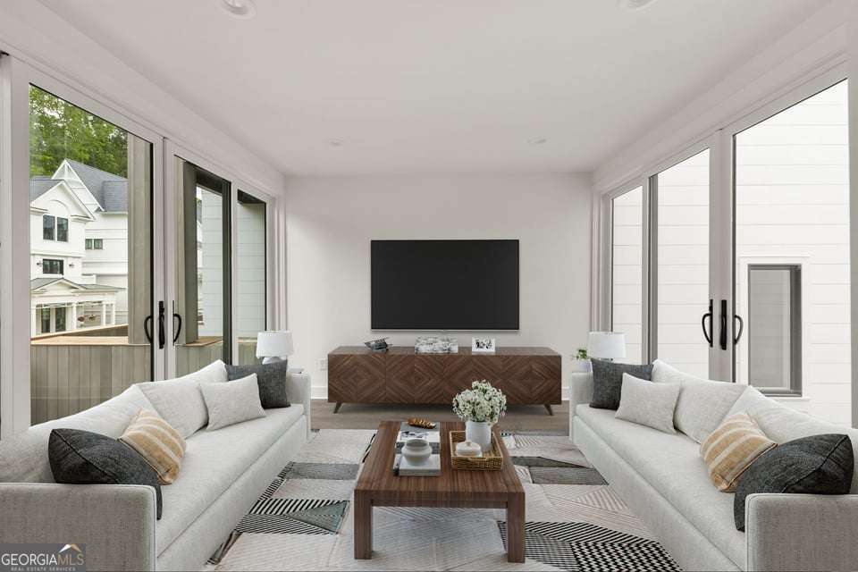 11554 Serenbe Lane Chattahoochee Hills, GA 30268 - Photo 10 of 16 a living room with furniture and a flat screen tv