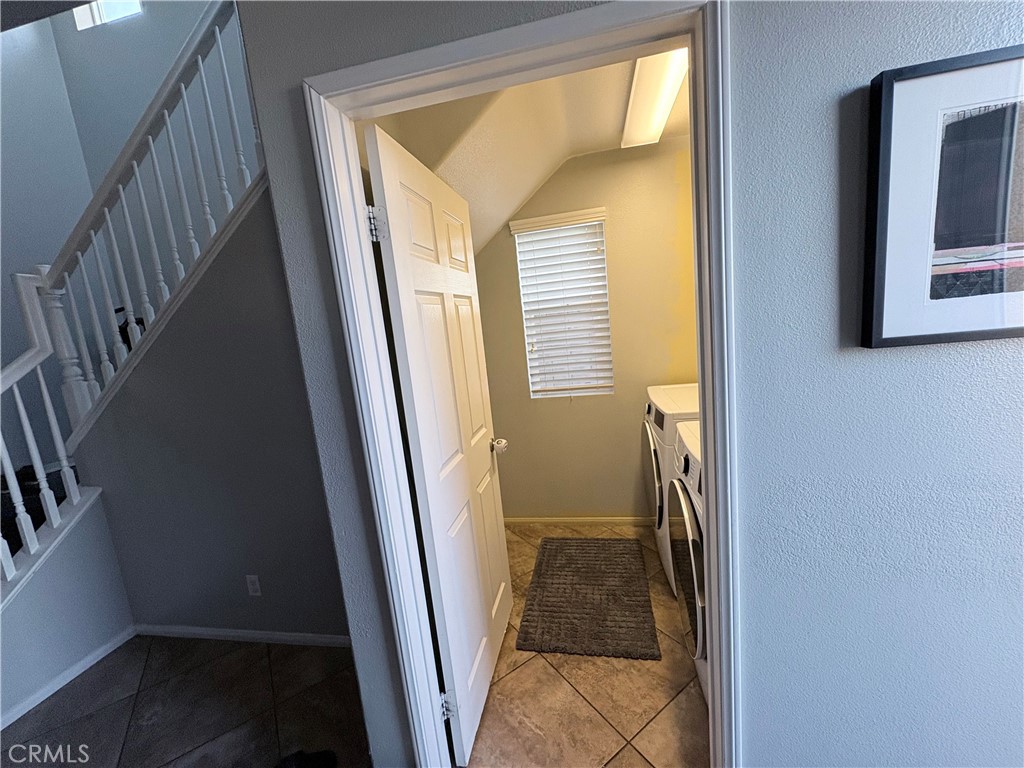 2729 Hornbeam Road Palmdale, CA 93551 - Photo 17 of 35 a view of a hallway with wooden floor and stairs