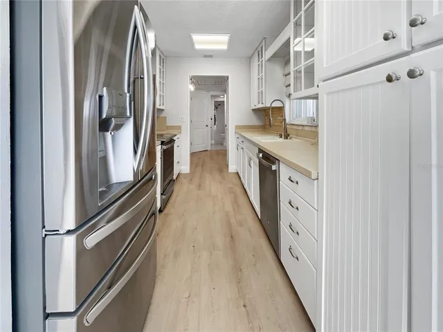 a kitchen with stainless steel appliances a refrigerator and a stove