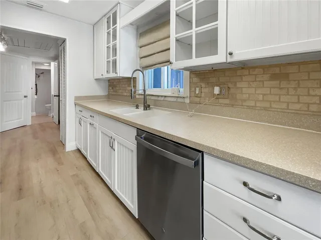 a kitchen with a sink and cabinets