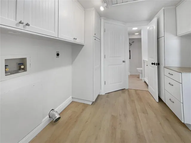 a view of a kitchen with white cabinets