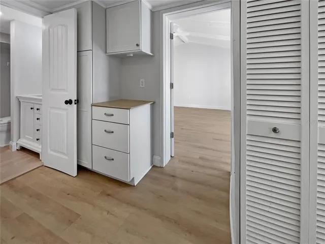 a view of a kitchen with white cabinets