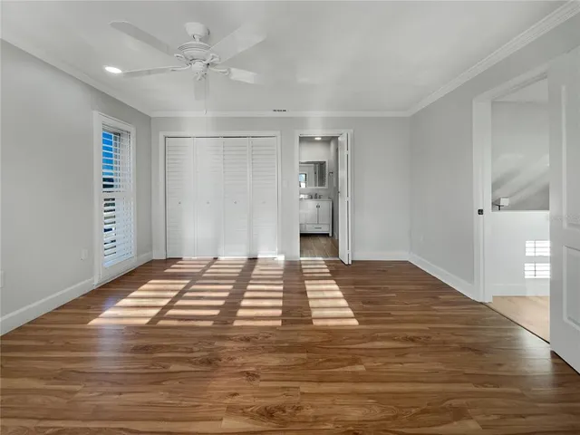 a view of a livingroom with wooden floor and a ceiling fan