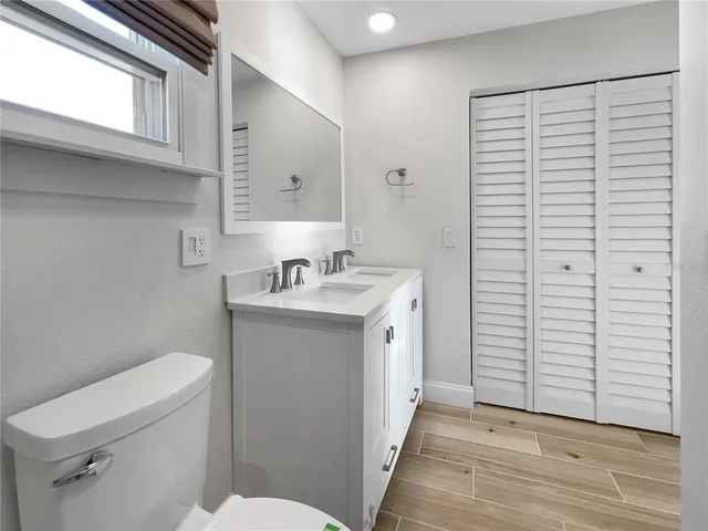 a bathroom with a sink a toilet and vanity