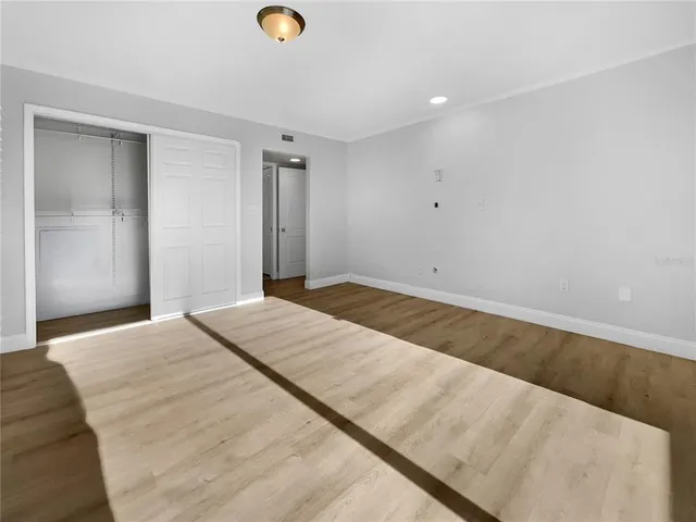 a view of a room with wooden floor