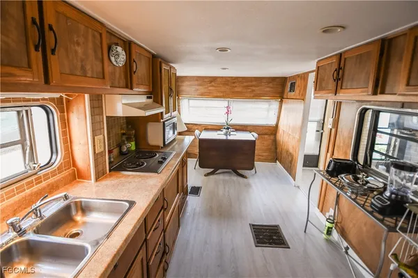 a kitchen with stainless steel appliances granite countertop a refrigerator stove top oven and sink