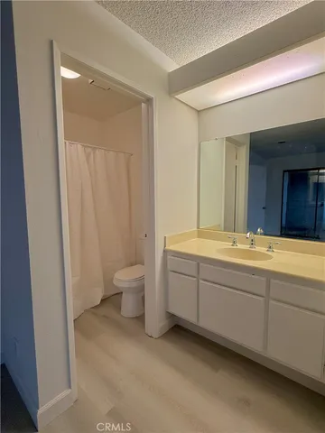 a spacious bathroom with a double vanity sink a toilet and a shower