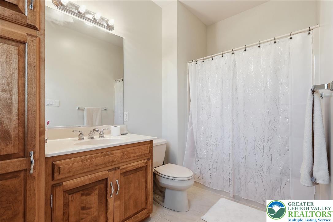 5217 Cider Press Road Schnecksville, PA 18078 - Photo 36 of 54 a bathroom with a sink a toilet and shower curtain