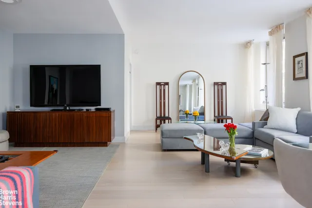 a living room with furniture and wooden floor