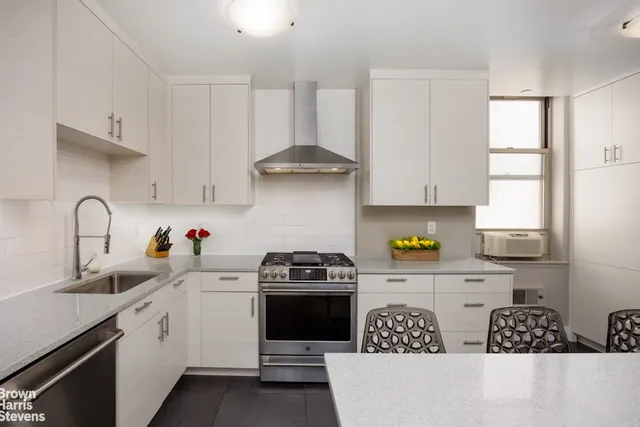 a kitchen with a sink a stove and cabinets