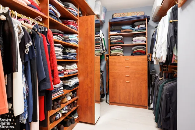 a bedroom with a large bed and a dresser