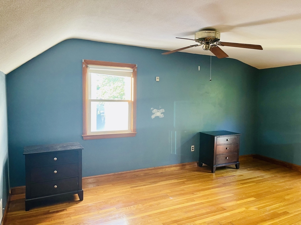 52 Westview Road Lynn, MA 01902 - Photo 13 of 32 a view of an empty room with a window and wooden floor