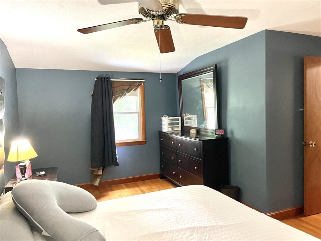 52 Westview Road Lynn, MA 01902 - Photo 14 of 32 a bedroom with a bed and a chandelier