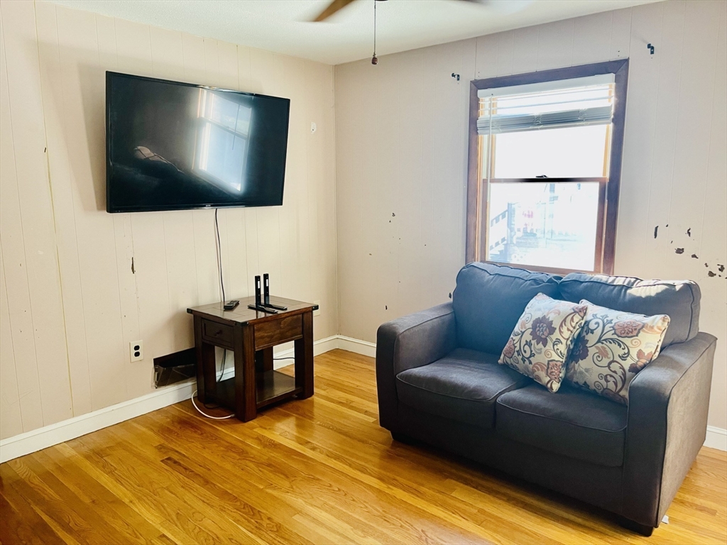 52 Westview Road Lynn, MA 01902 - Photo 23 of 32 a living room with furniture and a flat screen tv