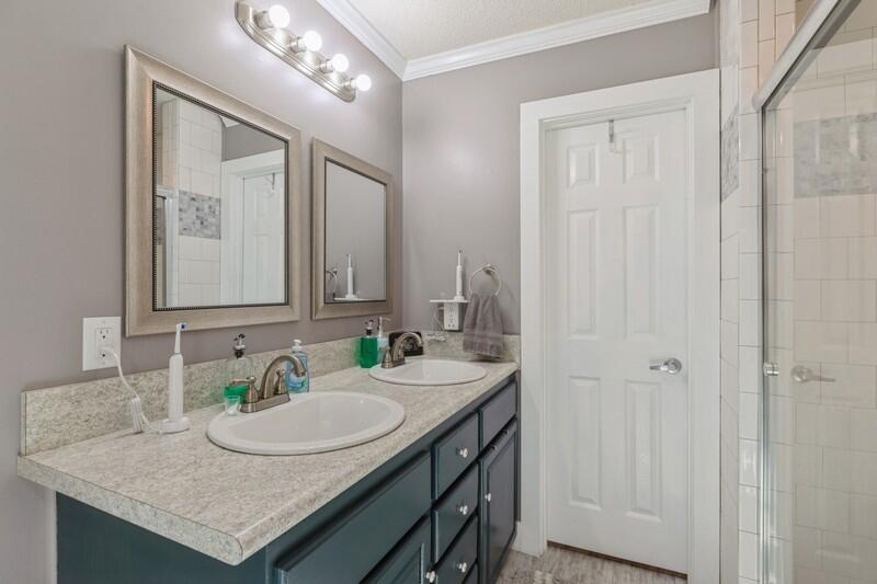 5540 Old River Road Baker, FL 32531 - Photo 15 of 37 a bathroom with a granite countertop sink and a mirror