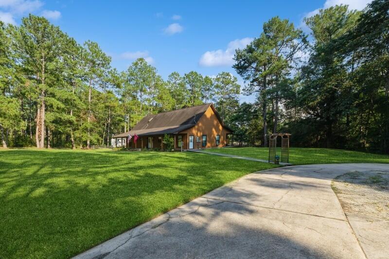 5540 Old River Road Baker, FL 32531 - Photo 3 of 37 a view of a backyard with large trees