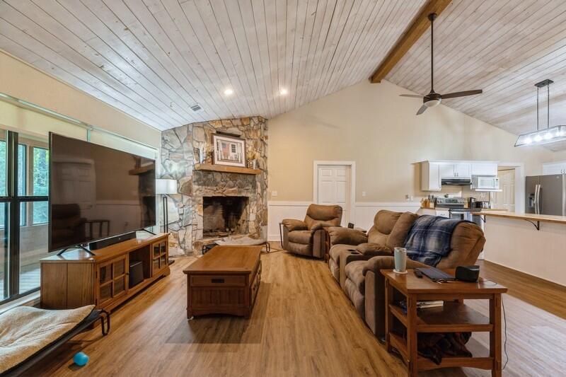 5540 Old River Road Baker, FL 32531 - Photo 5 of 37 a living room with furniture a flat screen tv and a fireplace