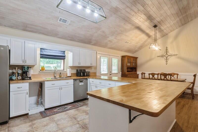 5540 Old River Road Baker, FL 32531 - Photo 10 of 37 a kitchen with kitchen island a sink stove and refrigerator