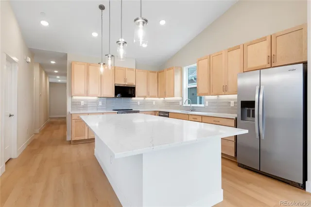 a bathroom with a sink a toilet a mirror and shower