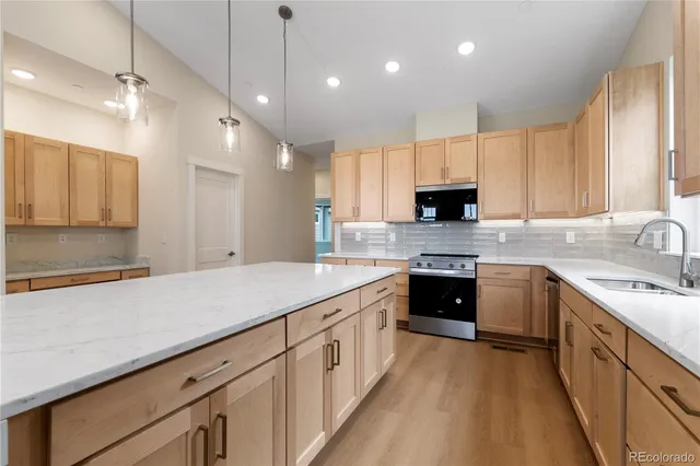 a kitchen with white cabinets and a window