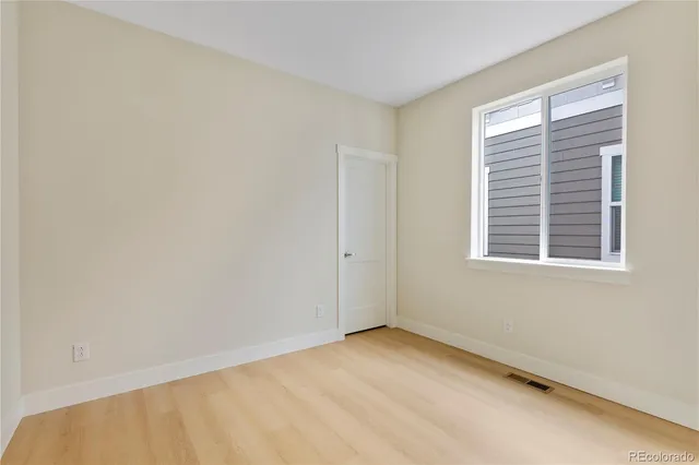 a bathroom with a granite countertop sink toilet and a mirror