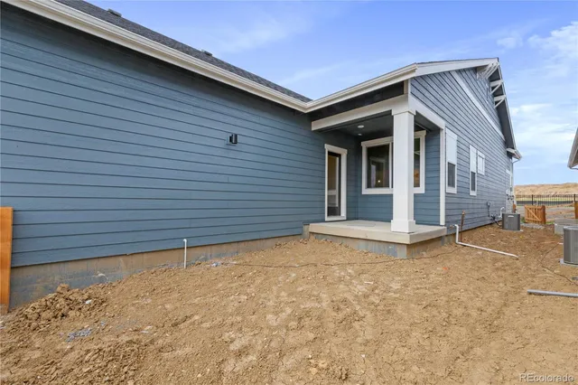 a large kitchen with a large counter top a sink stainless steel appliances and cabinets