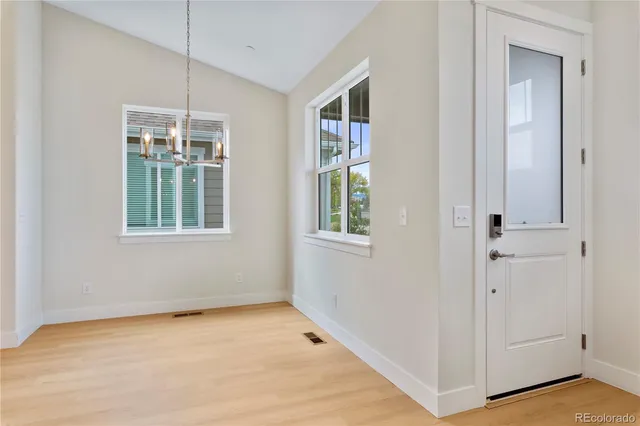 a large kitchen with kitchen island a large counter top and stainless steel appliances