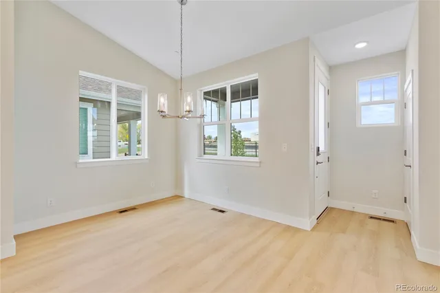 a kitchen with granite countertop a refrigerator and a sink