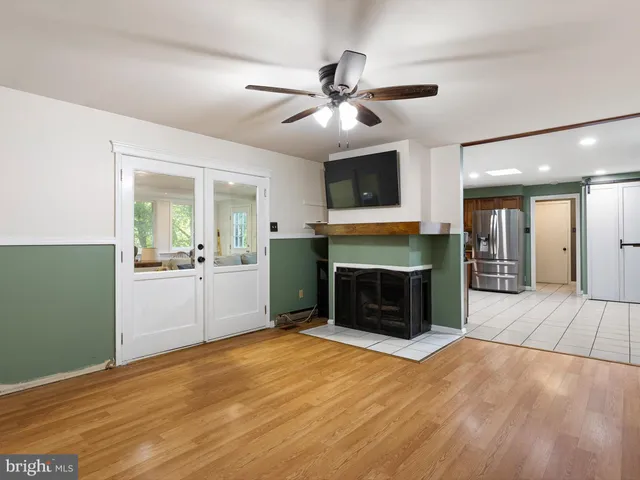 a view of an empty room with a fireplace and a window