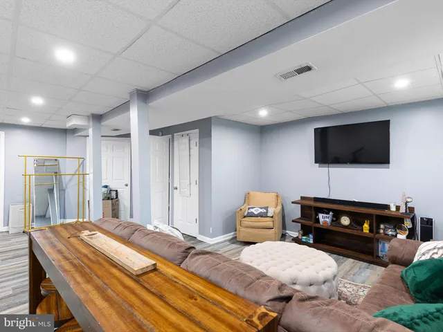 a spacious bedroom with a bed and a flat screen tv